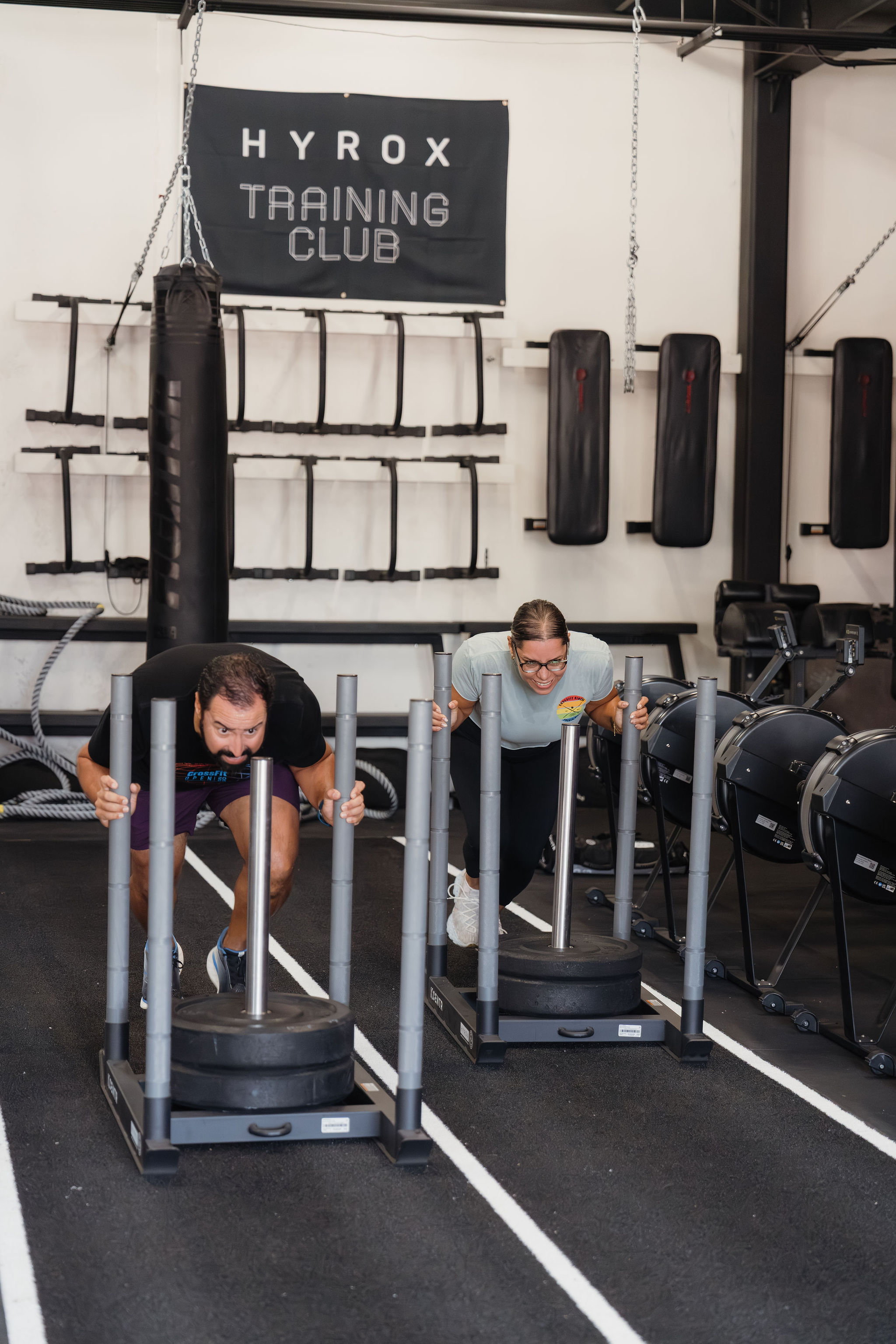 Athletes pushing a HYROX sled at RFC