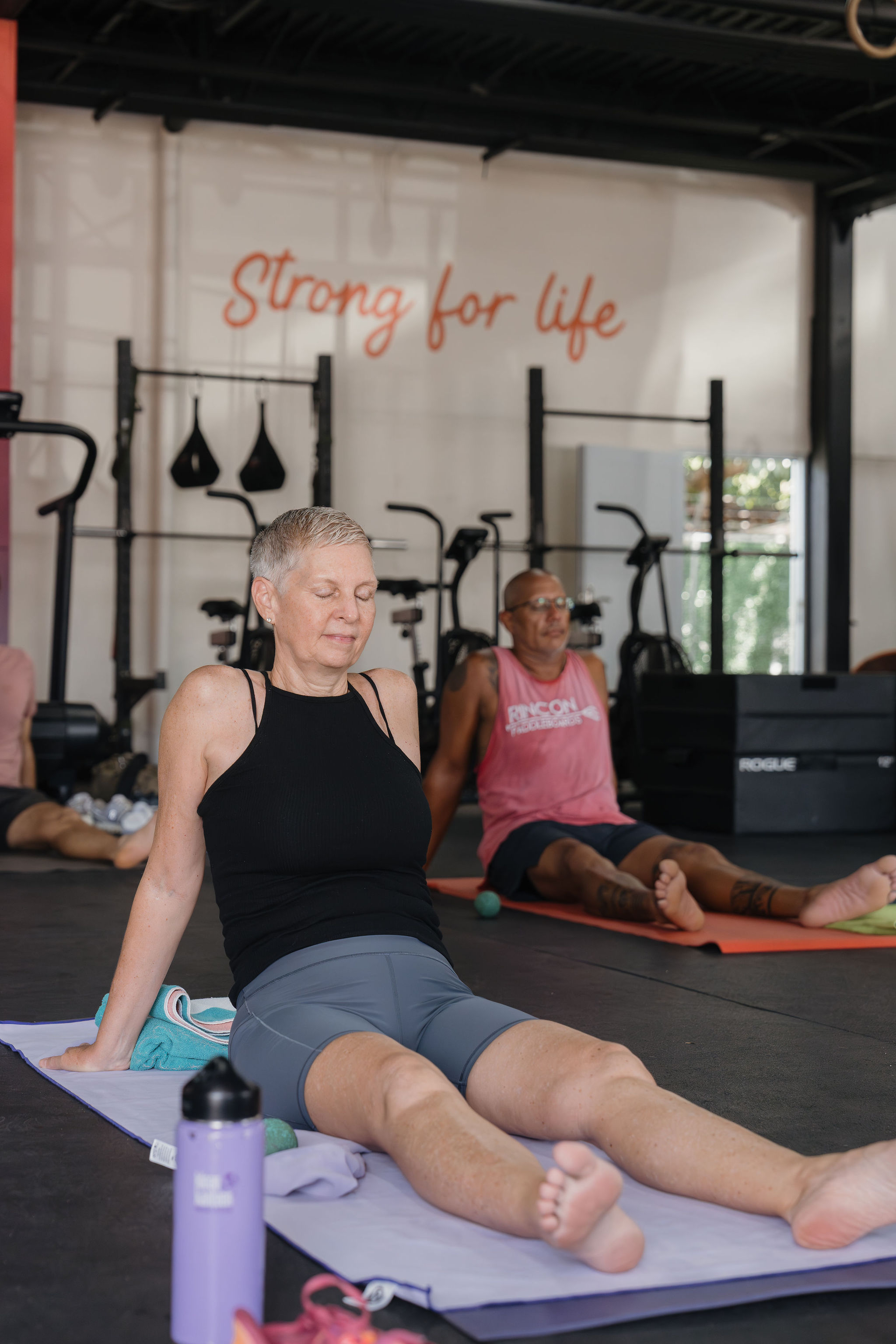 Member in Athletic Recovery class under the Strong for Life mural